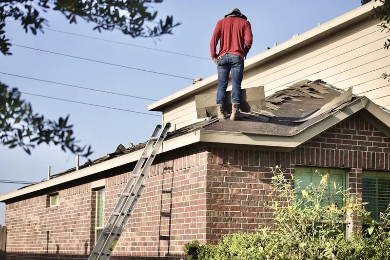 Professional roofer working on a residential roof in River Pines